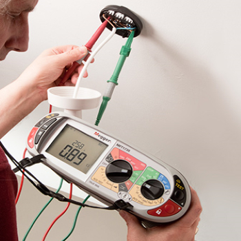 Electrician testing light fitting